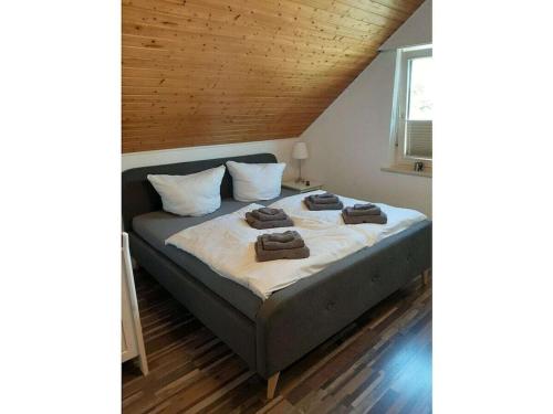 a large bed in a room with a wooden ceiling at Upper deck Comfortable holiday residence in Lindau