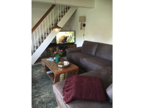 a living room with a couch and a table at Alte Gaststube Comfortable holiday residence in Nebel