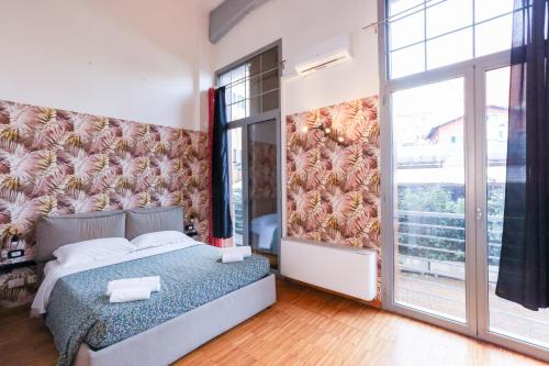 a bedroom with a bed and a large window at casa dolce casa in Rome