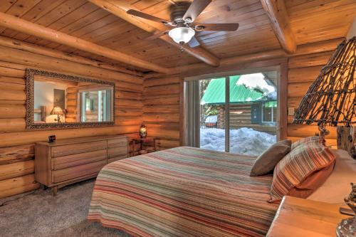 a bedroom with a bed and a ceiling fan at Cascade Cabin with Mountain View and River Access in Cascade
