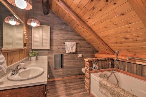 a bathroom with a sink and a tub in a log cabin at Cascade Cabin with Mountain View and River Access in Cascade