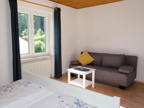 a living room with a couch and a table at Pension Sonnenberg Comfortable holiday residence in Silz