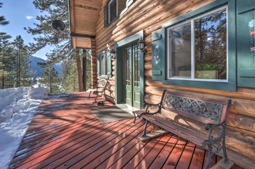 a wooden deck with a bench on a log cabin at Cascade Cabin with Mountain View and River Access in Cascade