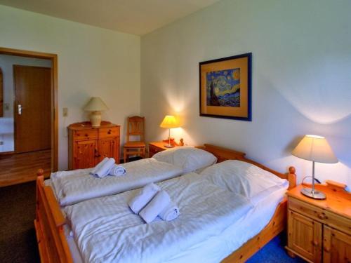 a bedroom with two beds with towels on them at Beach house F994 Comfortable holiday residence in Fehmarn