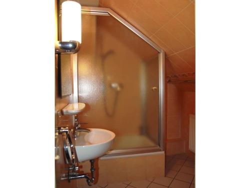 a bathroom with a sink and a shower at Beach house F994 Comfortable holiday residence in Fehmarn