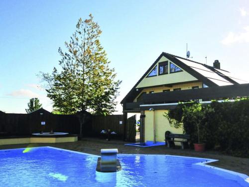 a swimming pool in front of a house at Holiday apartment by the swimming pool F 997 in Fehmarn
