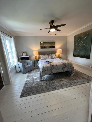a bedroom with a bed and a ceiling fan at Historic Charlottetown Twin Towers in Charlottetown
