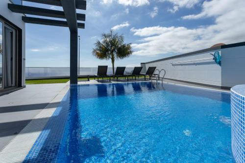 a swimming pool on the roof of a house at Villa Andrade Ocean View in Funchal
