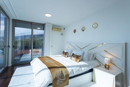 a bedroom with a bed and a large window at Villa Andrade Ocean View in Funchal