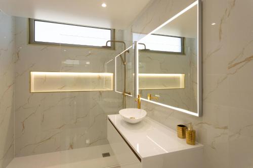 a bathroom with a sink and a mirror at Villa Andrade Ocean View in Funchal