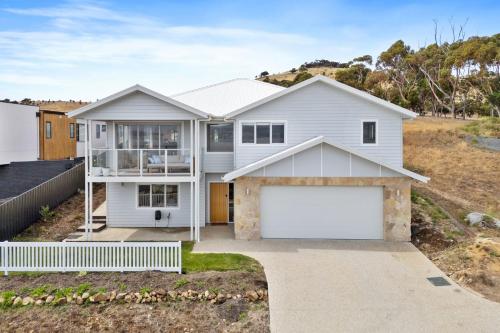a white house with a garage at Seaview Serenity in Tranmere