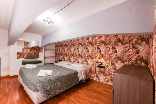 a bedroom with a bed and a wall with a mural at casa dolce casa in Rome