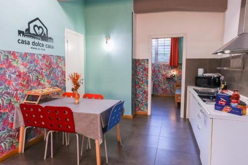 a kitchen with a table and chairs in a kitchen at casa dolce casa in Rome