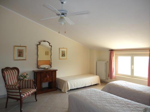 a bedroom with two beds and a ceiling fan at Casa Adriana in Penne