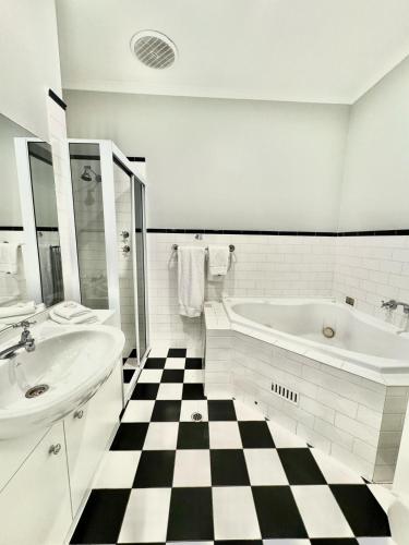 a bathroom with a black and white checkered floor at St Francis Winery in Old Reynella