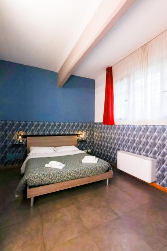 a bedroom with a bed and a red curtain at casa dolce casa in Rome