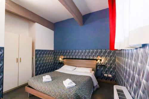 a bedroom with a bed with two white shoes on it at casa dolce casa in Rome