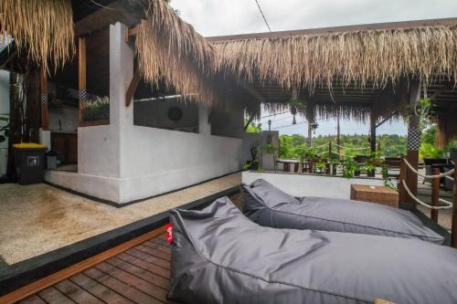 a resort with two pillows on a patio at Simpang Inn Hostel in Nusa Penida