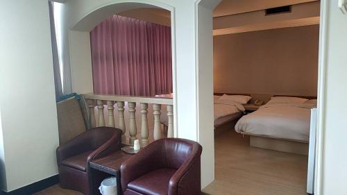 Postel nebo postele na pokoji v ubytování DC Hotel