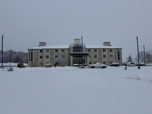 a building with a lot of snow in front of it at Baymont by Wyndham Kingdom City in Kingdom City