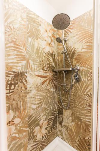 a bathroom with a shower with a plant wallpaper at casa dolce casa in Rome
