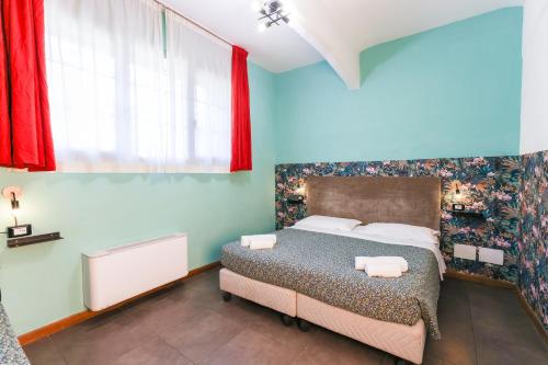 a bedroom with a bed and a red curtain at casa dolce casa in Rome