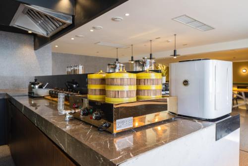 a kitchen with yellow barrels on a counter at Suisse place Hongqiao Shanghai in Shanghai
