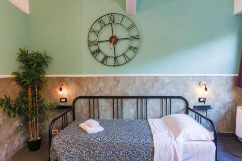 a bedroom with a bed and a clock on the wall at casa dolce casa in Rome