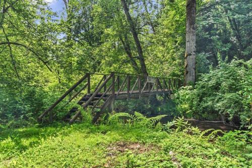 a wooden bridge in the middle of a forest at Cozy 7BR Farmhouse with Pool, Hot Tub, Sauna and More in Langley