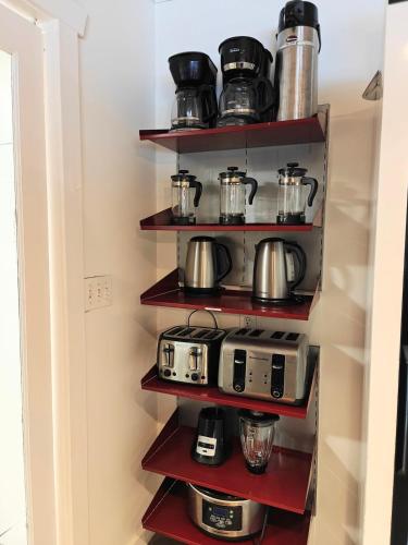 a kitchen with shelves with toaster and toasters at Cozy 7BR Farmhouse with Pool, Hot Tub, Sauna and More in Langley