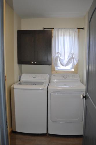 two washing machines in a room with a window at Relax & Unwind Cozy Farmhouse Near Natural Bridge State Park in Stanton