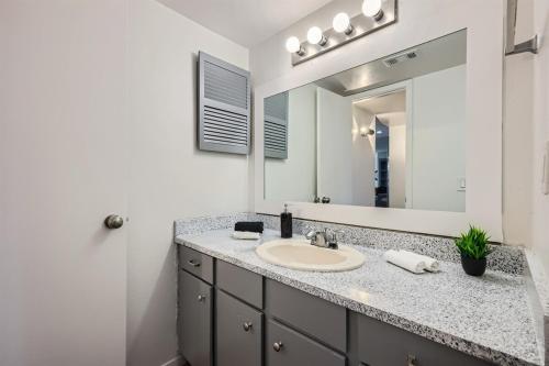 a bathroom with a sink and a mirror at Your Walkable King Bed Getaway - Sleeps 4 - Pool Pkg in Austin