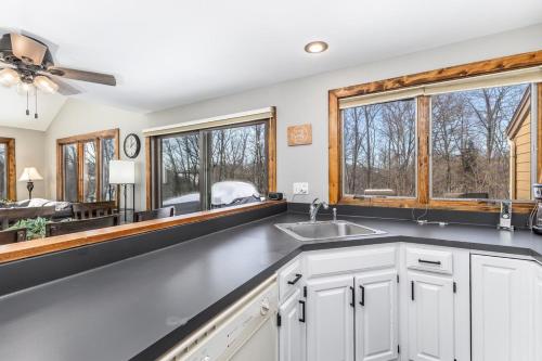 a kitchen with a sink and a large window at 4-Bedroom Townhouse in Beautiful Galena in Galena