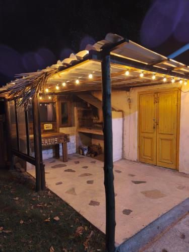 a pergola with lights on top of a patio at Alquilo casa en las Sierras de Minas "VIEJO RANCHO" in Minas