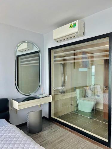 a bedroom with a large glass window and a bathroom at C-S-J TOWER - Luxury Near Beach Apartments - Căn Hộ Du Lịch Cạnh Biển Thành Phố Biển Vũng Tàu in Vung Tau