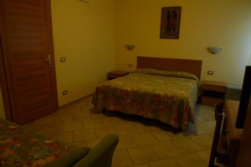 a hotel room with two beds and a door at Pensione Campese in Formia