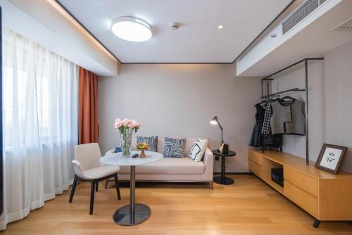 a living room with a couch and a table at Suisse place Hongqiao Shanghai in Shanghai
