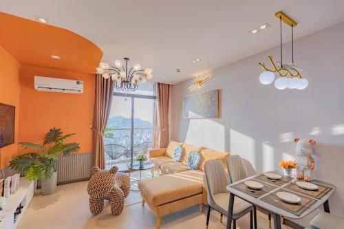 a living room with a couch and a table at C-S-J TOWER - Luxury Near Beach Apartments - Căn Hộ Du Lịch Cạnh Biển Thành Phố Biển Vũng Tàu in Vung Tau