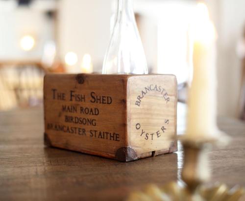 a wooden box sitting on top of a table at Black Lion Hotel in Little Walsingham
