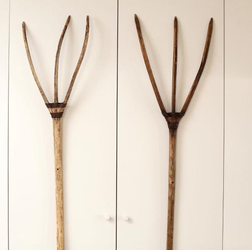a group of three wooden sticks hanging on a wall at Black Lion Hotel in Little Walsingham
