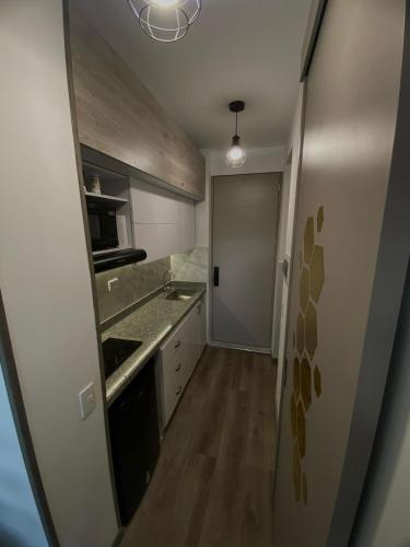 a small kitchen with a sink and a stove at Blessing House in Bogotá