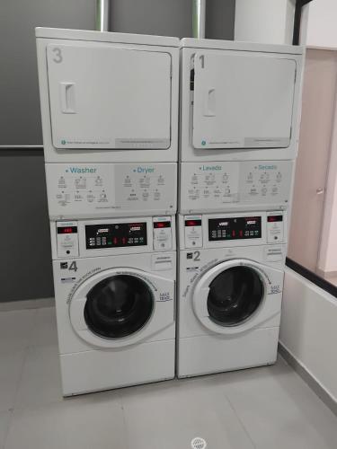 three washing machines stacked on top of each other at Blessing House in Bogotá