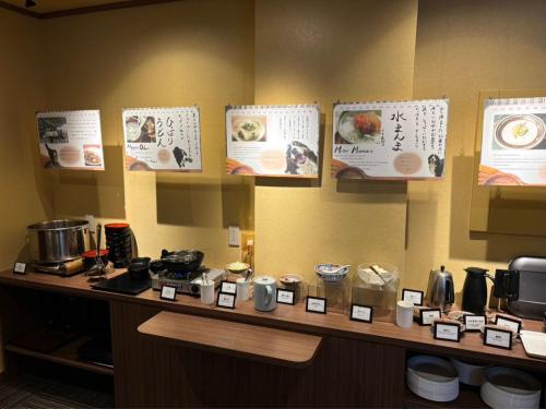 a counter in a restaurant with signs on the wall at Mogamitakayu Zenshichinoyu Ohira in Zao Onsen