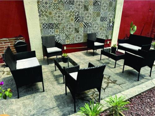 a group of chairs and tables on a patio at Casa Cañonero, a magic place, tepextate room in Oaxaca City