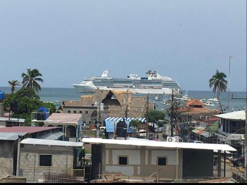 a cruise ship in the ocean with a city at Casa central in San Juan del Sur