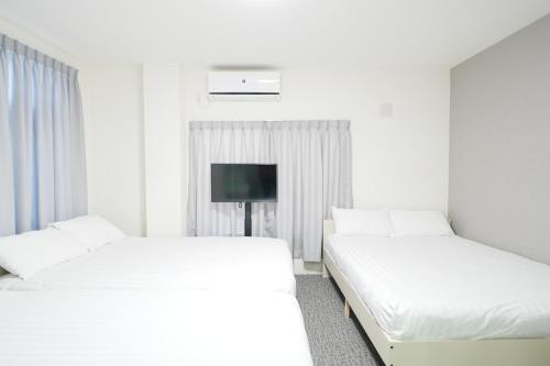 Minami Koiwa - Stay in a Traditional Tokyo Shopping Street with Quick Trip to Shinjuku & Akihabaraにあるベッド