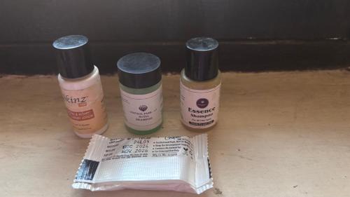 three bottles of glue sitting next to a piece of paper at Vrinda stays in Chhatikara