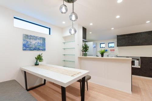 a kitchen and dining room with a white table at 福吉屋 in Tokyo