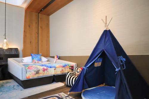 a bedroom with a bed and a blue tent at The Westin Yantai in Yantai