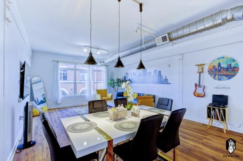 a dining room and living room with a table and chairs at The Stallion #208 - Walk to Attractions - Modern Luxe Loft in Memphis Downtown with free covered gated parking in Memphis